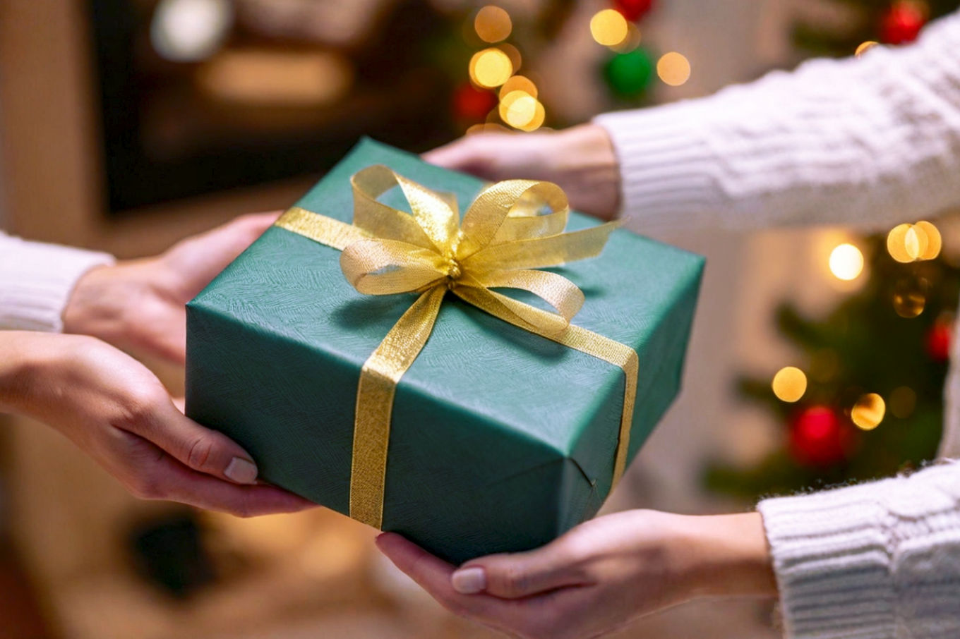 Professional, lifelike photograph of a beautifully wrapped, moderately sized gift box with a festive ribbon, surrounded by several hands reaching out, subtly hinting at a playful 'stealing' motion. The background is a softly blurred, warm, inviting home party setting with festive lights. The lighting is soft and inviting, highlighting the gift as the central focus. The mood is joyful and anticipatory. Core theme: highly desired, universally appealing Yankee Swap gift.