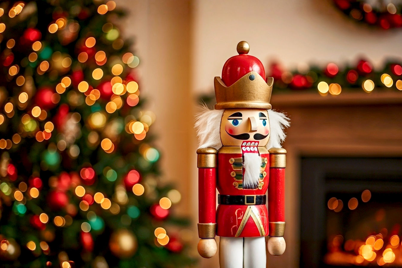 Subject: A beautifully decorated living room during Christmas, prominently featuring a grand, traditional wooden Nutcracker soldier (around 3-4 feet tall) standing elegantly beside a festive Christmas tree. Composition: The Nutcracker should be in the foreground, slightly off-center, drawing the eye. The Christmas tree, adorned with classic red, green, and gold ornaments, and warm white lights, should be in the mid-ground, slightly blurred to create depth of field. A cozy fireplace mantel with a garland and smaller Nutcracker figures should be visible in the background. Lighting: Soft, warm, inviting indoor lighting, with emphasis on the glow of Christmas tree lights and subtle ambient light from the room. A gentle bokeh effect around the background elements. Mood: Enchanting, nostalgic, elegant, and festive. Evokes a sense of classic Christmas magic and warmth. Style: Lifelike, professional photography. High-resolution, sharp focus on the Nutcracker, rich colors, and exquisite detail. No people or text.