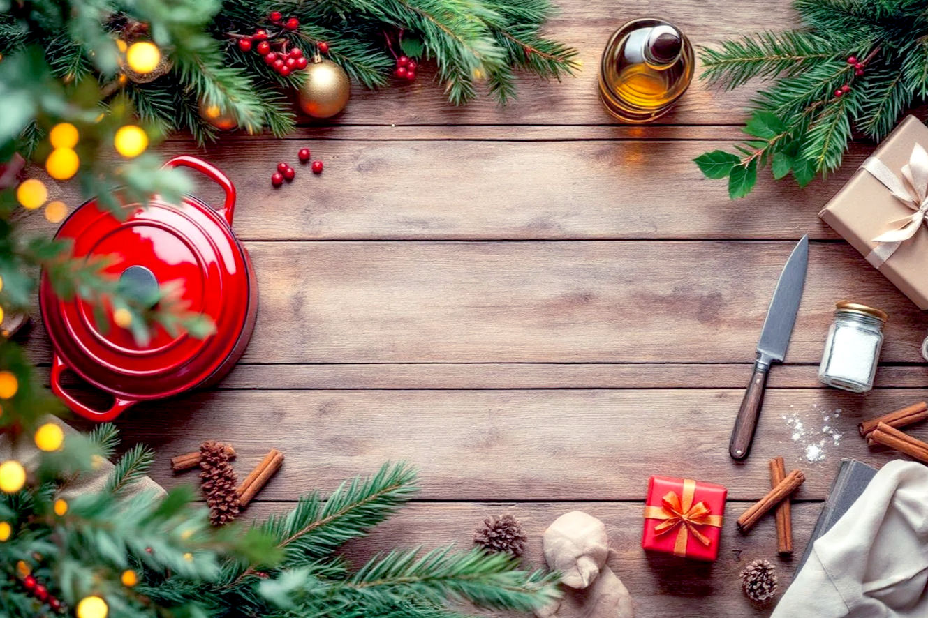 Create a vibrant, lifelike, professional photography style image. The composition is a flat lay on a warm, rustic wooden table. The scene is filled with meticulously arranged, high-end Christmas gifts for a foodie. Key elements include a shiny, sharp chef's knife, a vibrant red enameled cast iron Dutch oven, a small jar of artisanal sea salt, a bottle of premium olive oil, and a beautiful food-themed cookbook. The items are interspersed with subtle holiday decorations, such as pine sprigs, a few cinnamon sticks, and a perfectly wrapped small gift box tied with a festive ribbon. The lighting is soft and warm, with a shallow depth of field that keeps the gifts in focus while blurring the background slightly. The overall mood is cozy, festive, and luxurious. The image should be rich in color and texture, with a clean, high-end aesthetic.